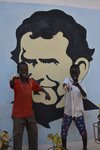 zwei afrikanische Jungs vor gemaltem Don Bosco